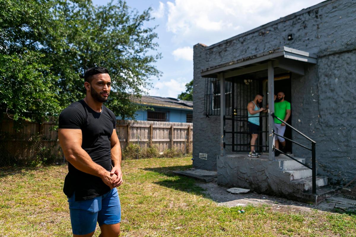 From left: Guillermo Hernandez, 29, Jonatan Lopez, 33, and Damian Camarotta, 33, are living in an abandoned home in Liberty City after their return flights home were canceled due to the coronavirus. Their priority is conserving funds because their money is running out. “We’re grateful for the roof over our heads, but we are worried.”