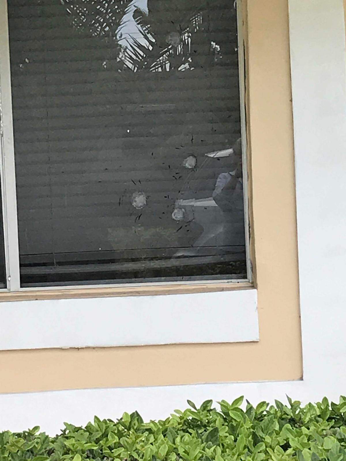 Bullet holes in the front window of the Khosravi home in Kendall where Aramis Khosravi is accused of trying to kill 10 Miami-Dade police officers during a shootout Tuesday night.