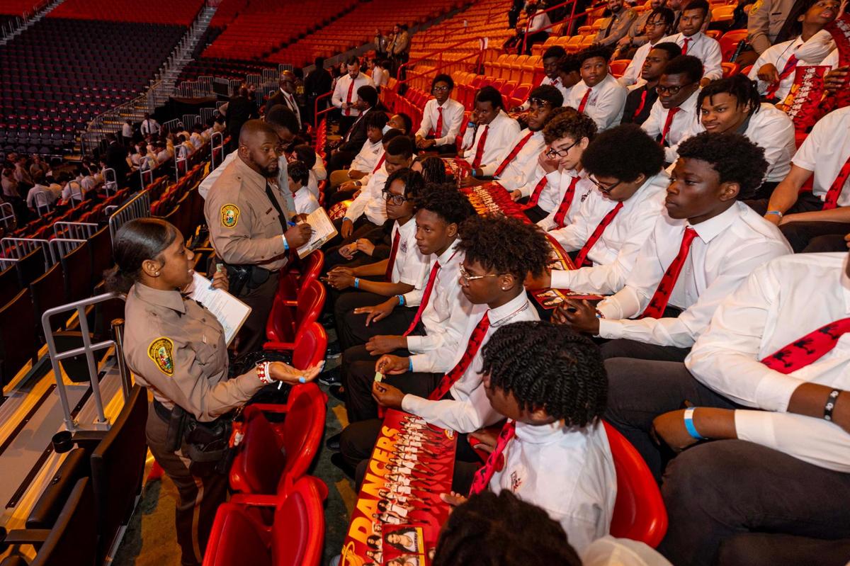 Miami-Dade County Police Officers speak to members of the 5000 Role Models to discuss problems and solutions for policing during the annual 5000 Role Models Police & Youth Conference.