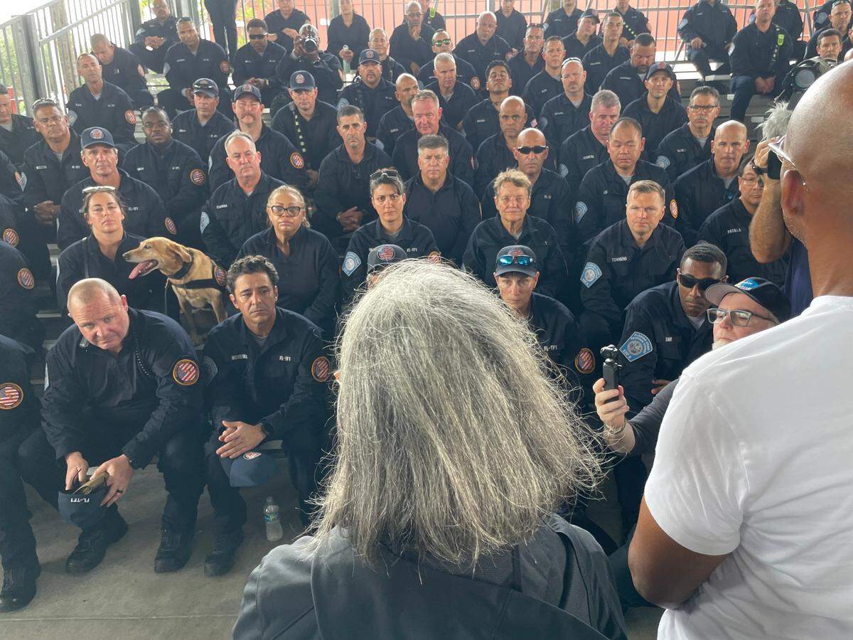 Miami-Dade County’s Urban Search and Rescue team listens to remarks from Mayor Daniella Levine Cava on Wednesday, Oct. 9, 2024, as it prepares to deploy into the aftermath of Hurricane Milton. Standing to Levine Cava’s right is Oliver Gilbert, chair of the Miami-Dade County Commission.