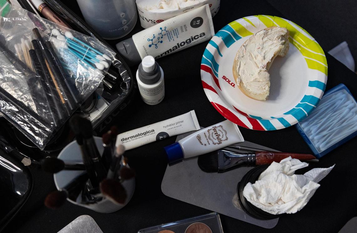 Lee’s makeup table, pictured before she had the chance to organize the makeup by actor. She took bites of her bagel with cream cheese in between doing actors’ makeup, making sure to sanitize her hands before touching the makeup and the actors.