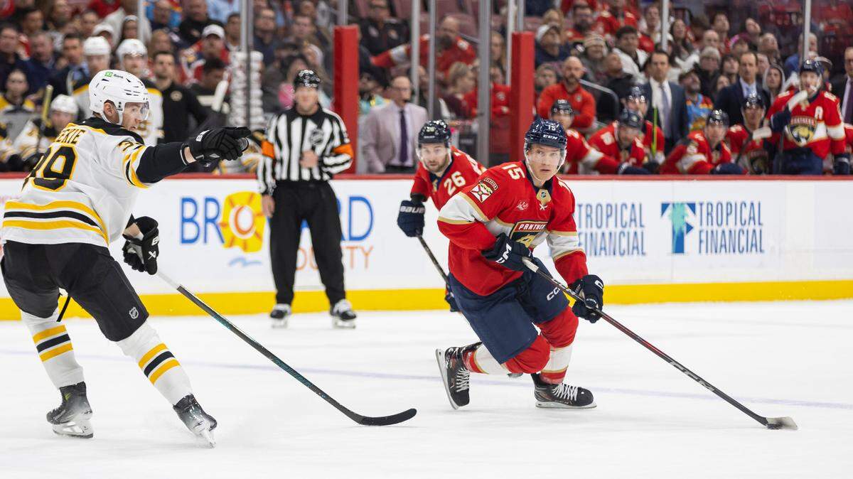 Florida Panthers center Anton Lundell (15) skates with the puck as Boston Bruins center Morgan Geekie (39) defends in the first period of their NHL game at Amerant Arena on Saturday, Jan. 11, 2025, in Sunrise, Fla.