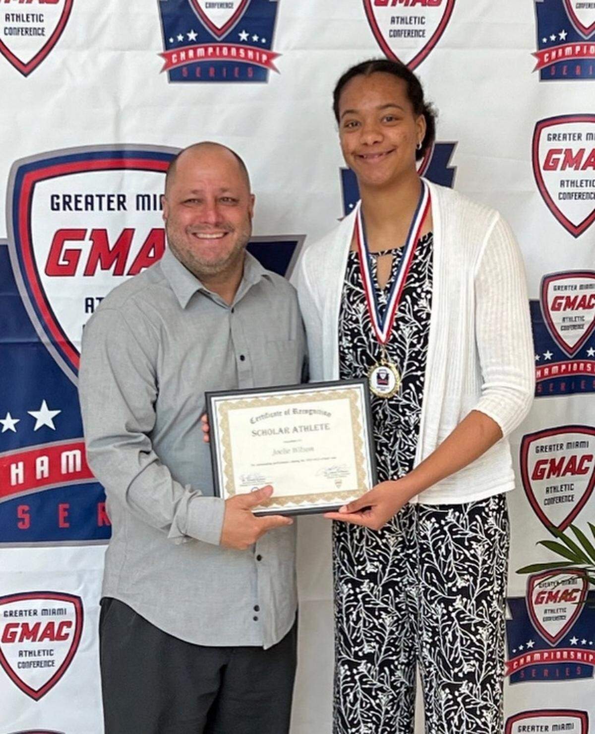Miami High basketball/volleyball star Joelle Wilson (right), seen here with her basketball coach Sam Baumgarten (left), is the Miami Herald’s Dade Girls’ Scholar Athlete of the Year.