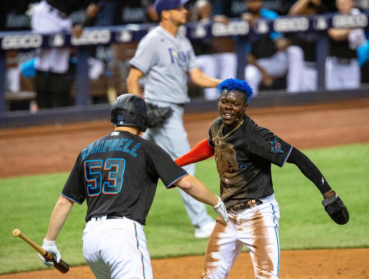 Miami Marlins Jazz Chisholm Jr.&nbsp;(2) and Paul Campbell&nbsp;(53) react after Chisholm Jr. scored off a sacrifice fly by catcher Chad Wallach&nbsp;(17) during the fourth inning of an MLB game against the Tampa Bay Rays at loanDepot park in the Little Havana neighborhood of Miami, Florida, on Saturday, April 3, 2021.