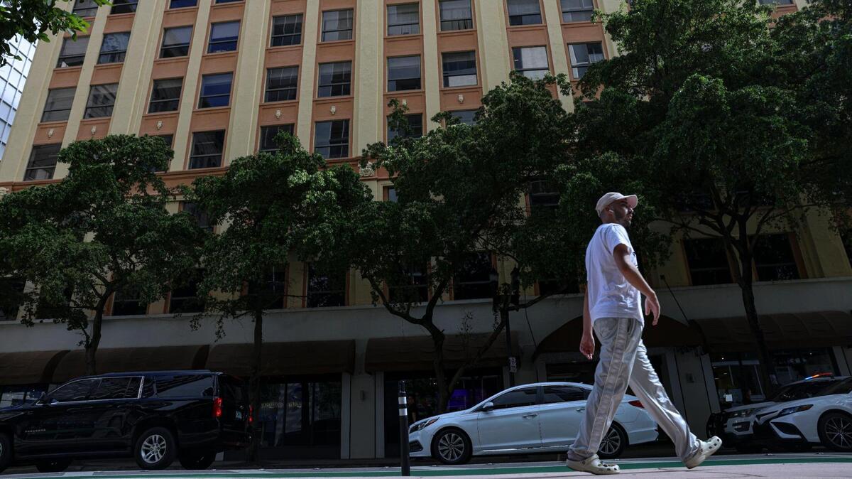 A man walks in front of the Huntington Building on Thursday, March 23, 2023, in downtown Miami. The building was shut down by the city last week over a ‘life safety’ issue.