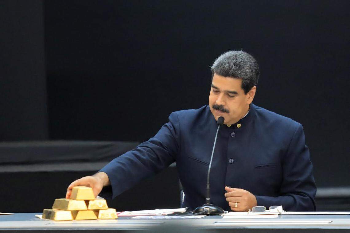 Venezuela’s President Nicolas Maduro touches a gold bar as he speaks during a meeting with the ministers responsible for the economic sector at Miraflores Palace in Caracas, Venezuela, March 22, 2018.