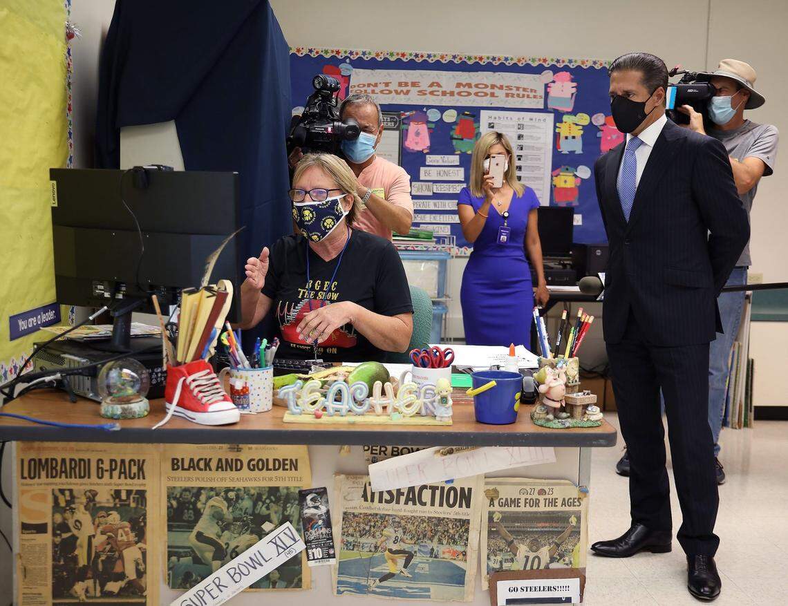 Kimberly Ottaviani, second grade TEAM teacher, instructs students remotely as Miami-Dade Schools Superintendent Alberto Carvalho, right, stopped by the Bob Graham Education Center in Miami Lakes to welcome back school-site administrators and teachers as they engaged in the My School Online instruction from various respective classrooms on Monday, Aug. 31, 2020.