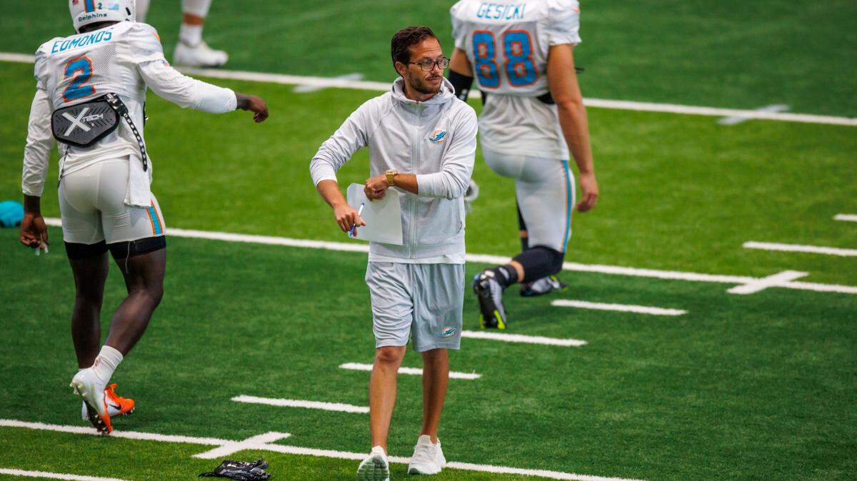 Miami Dolphins head coach Mike McDaniel walks as players running drills during NFL football training camp at Baptist Health Training Complex in Hard Rock Stadium on Thursday, August 18, 2022 in Miami Gardens, Florida.