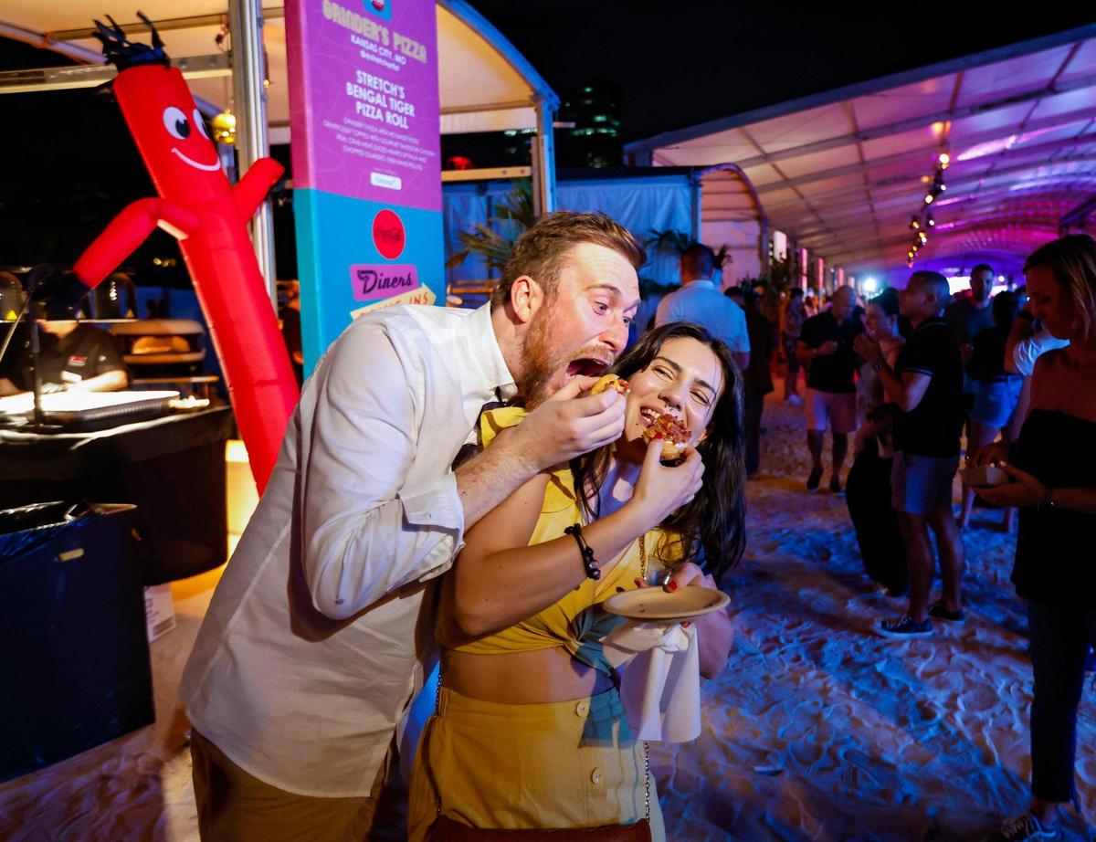 Stu Colbert and LA Loschiavo enjoy the food at the South Beach Wine & Food Festival on the sand by the Ritz Carlton in Miami Beach, Florida on Saturday, February 25, 2023.
