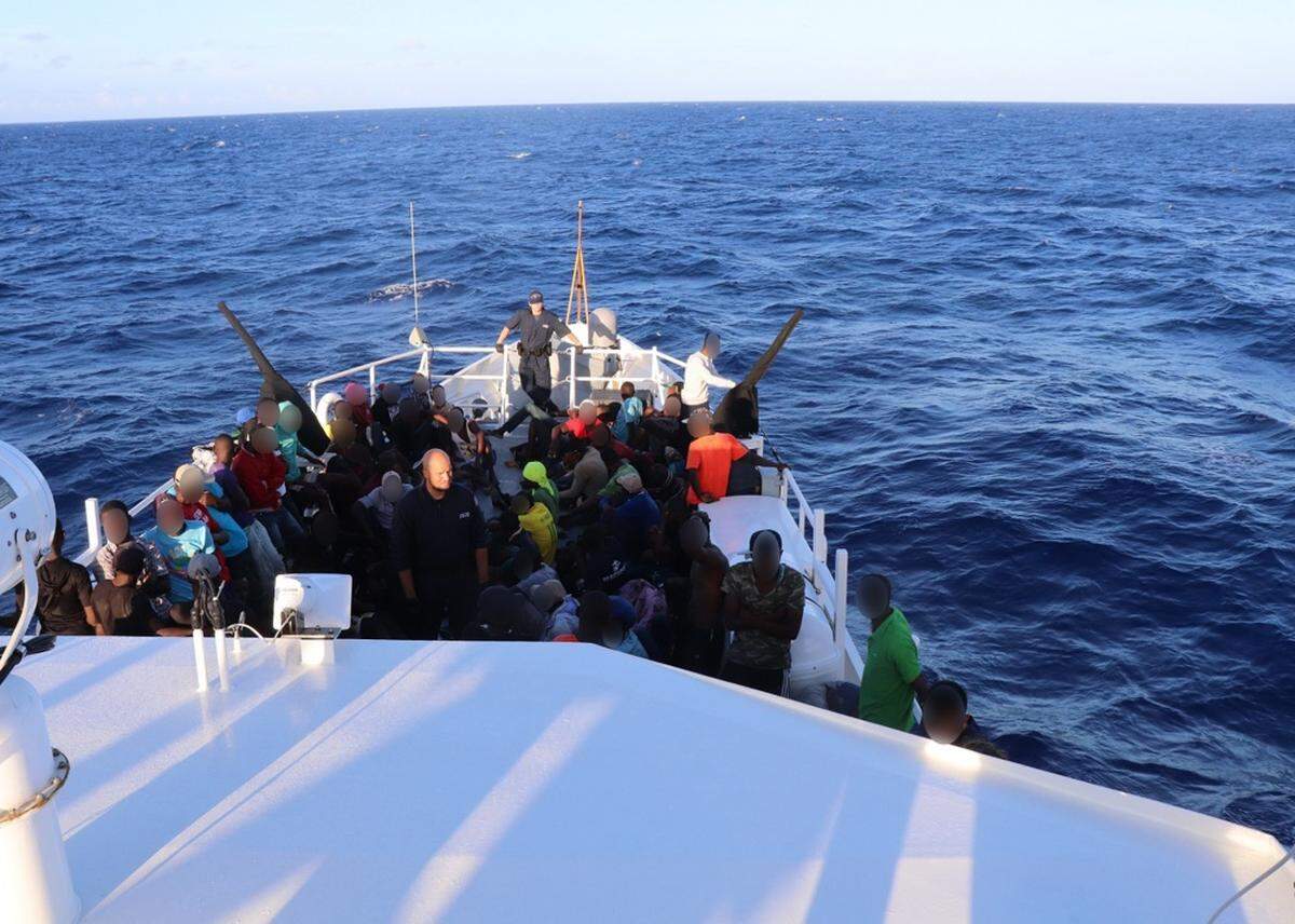 Some of the 146 Haitians intercepted at sea Sunday on the bow of the U.S. Coast Guard Cutter William Trump