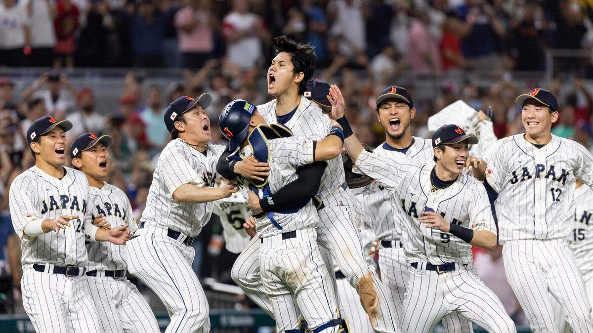 Japan pitcher Shohei Ohtani (16) celebrates with his teammates after defeating the United States in the championship game at the World Baseball Classic at loanDepot Park on Tuesday, March 21, 2023, in Miami, Fla.