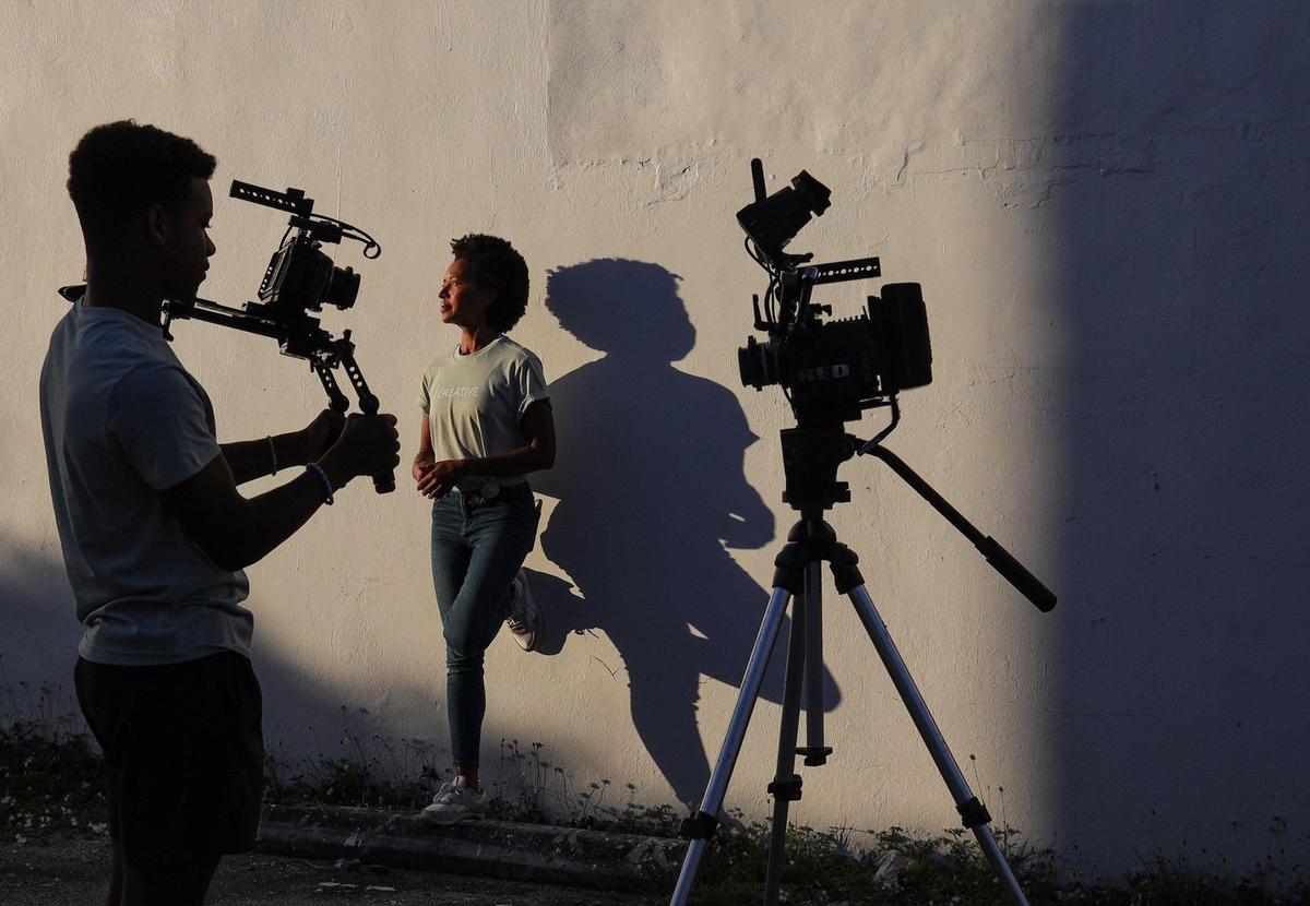 Creative Media Group founder Maria Taylor, 43, right, stands near Giovanni Carter, 18, left, one of the young filmmakers her company helps to learn about film production on Jan. 6, 2022, in Miami.