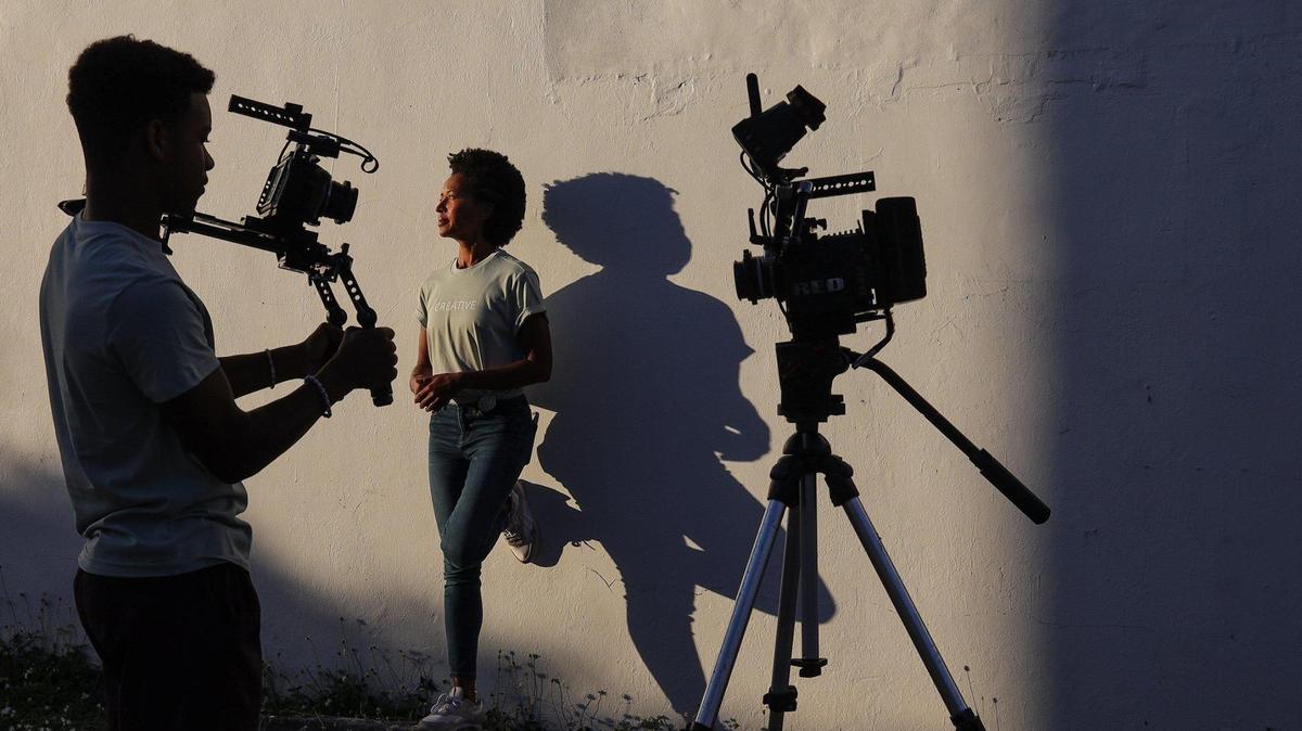 Creative Media Group founder Maria Taylor, 43, right, stands near Giovanni Carter, 18, left, one of the many young filmmakers her company helps to learn about film production on Thursday, Jan. 6, 2022, in Miami, Florida.