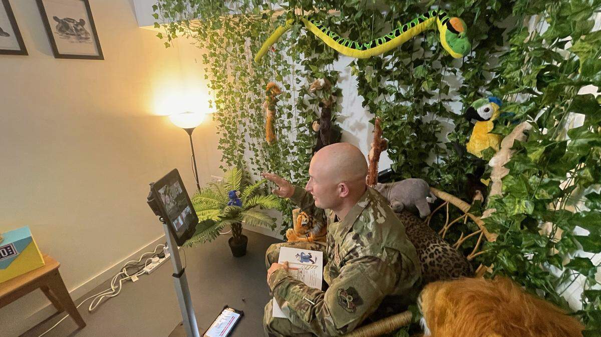 Air Force 1st Lt. Arnold A. Perez, currently stationed in the United Arab
Emirates, reads to students at the Chapman Partnership through Zoom. 
