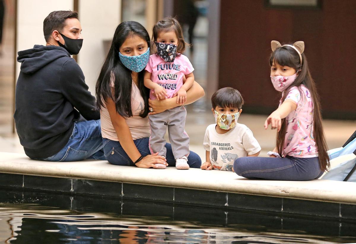 Jozbin Santana with his wife, Ana, and their children Rudharani 1, Govinda 3, and Joshianelly 8, at Aventura Mall, May 25, 2020. The mall was an alternative to traditional Memorial Day activities as rain inundated the area.