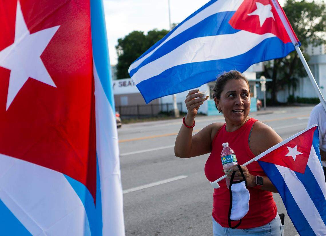An activist drinks Cuban coffee during a rally outside of Versailles on July 20, 2021. A group gathered in solidarity with the anti-government protests happening in Cuba.