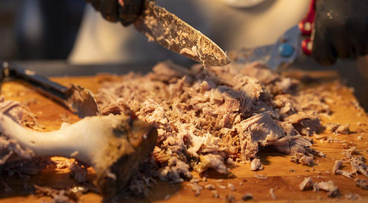 Ari Valerio, with El Sazon, prepares pork shoulder for guests attending the Goya Foods' Grand Tasting Village during the Food Network South Beach Wine & Food Festival on Saturday, Feb. 21, 2026, in Miami Beach, Fla.