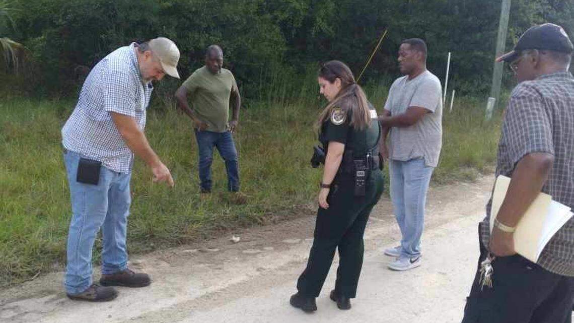 A member of Dr. Marvin Dunn’s group shows a Levy County Sheriff’s Deputy skid marks left behind during an alleged confrontation with a neighbor