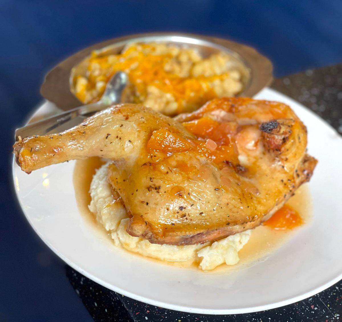 Peach-glazed roast chicken with mac & cheese at Crackers in Miami Springs
