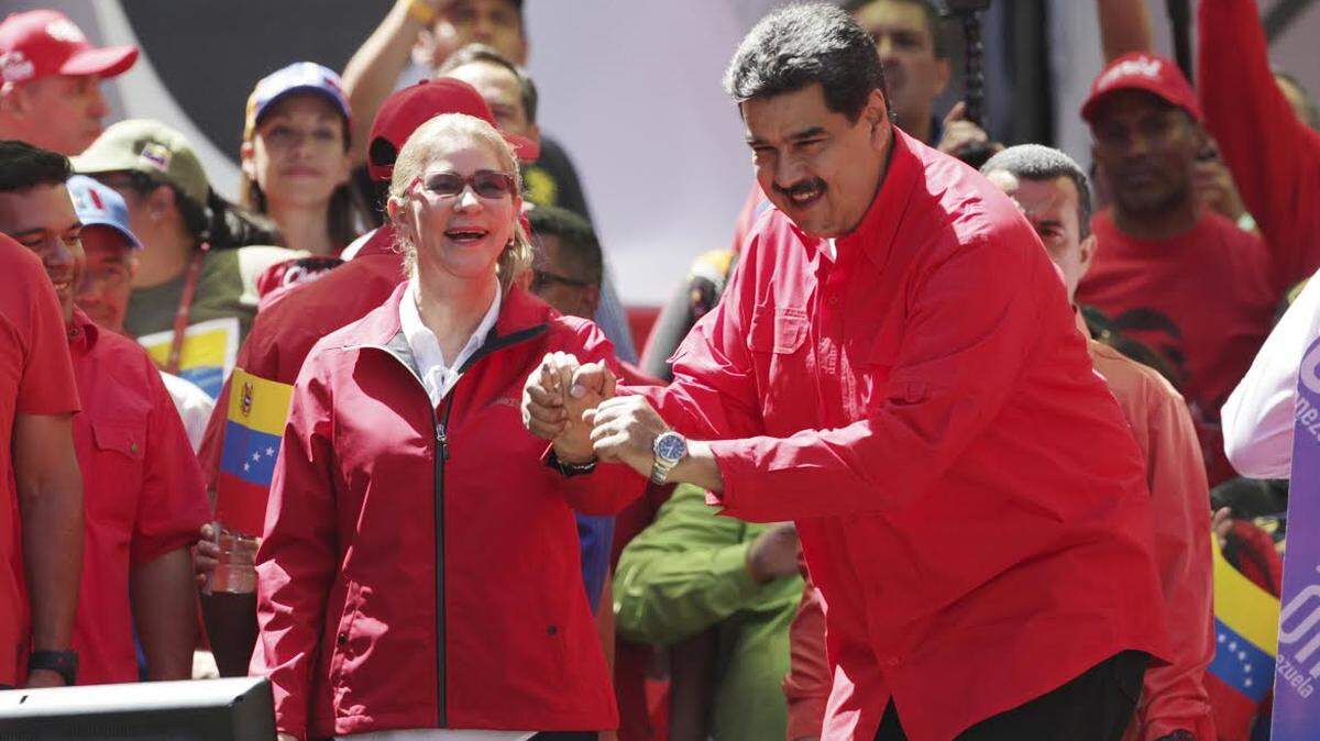 Venezuela’s President Nicolás Maduro dances with first lady Cilia Flores during a pro-government rally in Caracas.