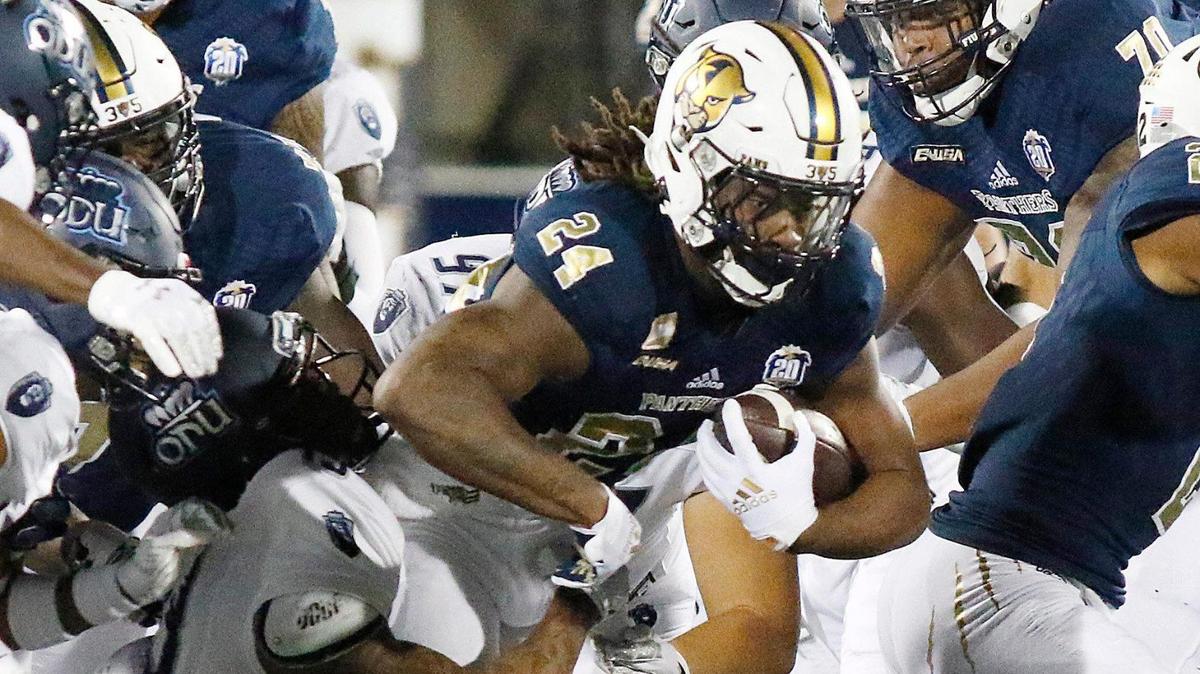 FIU Panthers running back D’vonte Price (24) is taken down by Old Dominion Monarchs defenders during football game Saturday, Nov. 6, 2021 at Riccardo Silva Stadium in Miami. Andrew Uloza / for THE MIAMI HERALD