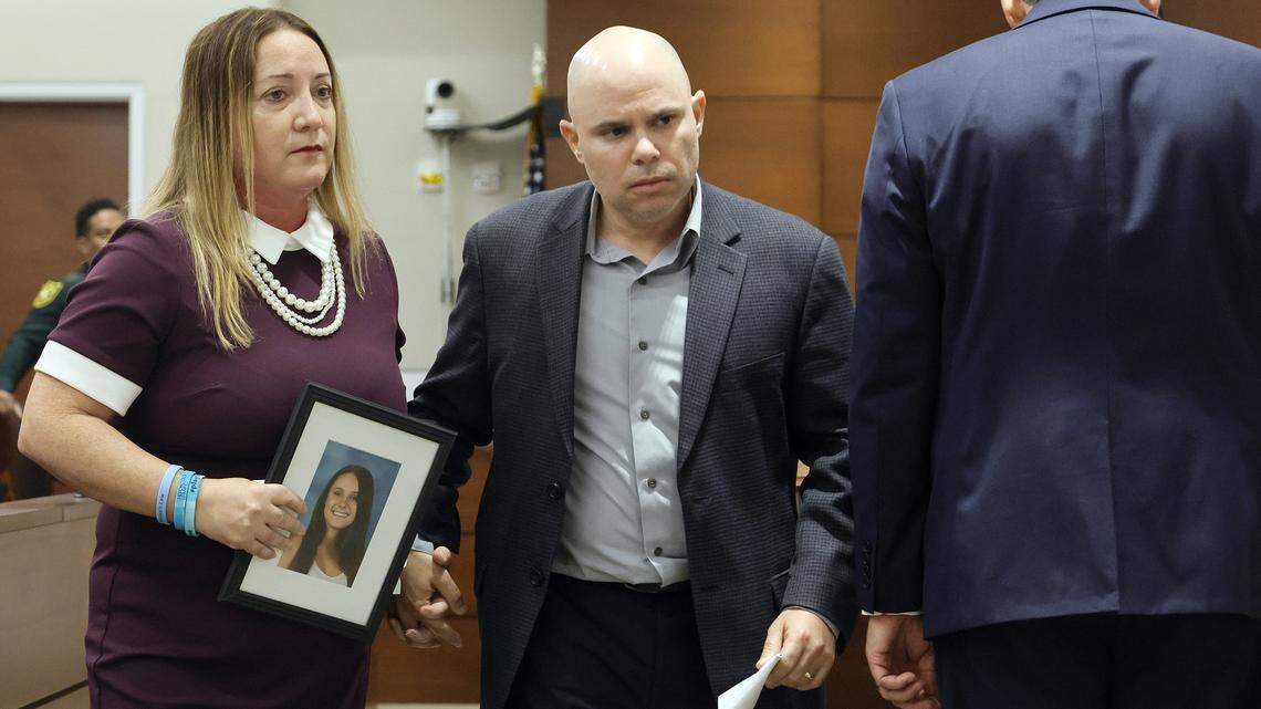 Lori and Ilan Alhadeff leave the podium after giving their victim impact statement during the sentencing hearing for Marjory Stoneman Douglas High School shooter Nikolas Cruz at the Broward County Courthouse in Fort Lauderdale on Wednesday, Nov. 2, 2022. Lori carries a photograph of their daughter, Alyssa, who was killed in the 2018 shootings.