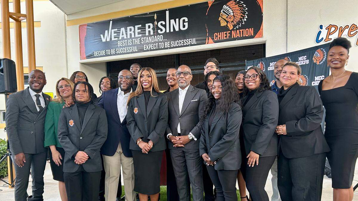 Ten Miami Carol City High students are flanked by elected and school district officials in front of the Miami Gardens school Tuesday, Oct. 24, 2023, before they head to Washington, where they will meet with President Joe Biden, First Lady Jill Biden and Vice President Kamala Harris. The students were chosen for their academic and leadership skills.