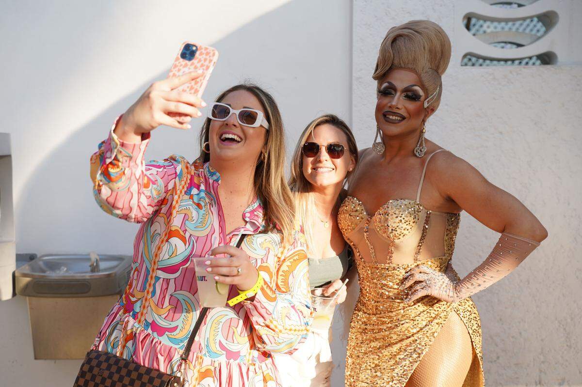 Fans snap a selfie with Athena Dion, who will host this year’s Drag Bunch on the beach, at the 2025 South Beach Wine & Food Festival.