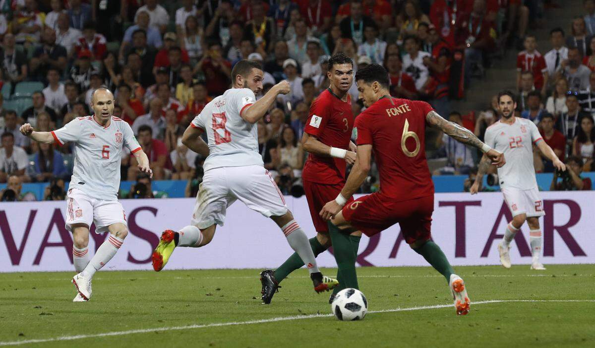 Spain's Andres Iniesta, left shoots at goal during the group B match between Portugal and Spain at the 2018 soccer World Cup in the Fisht Stadium in Sochi, Russia, Friday, June 15, 2018.