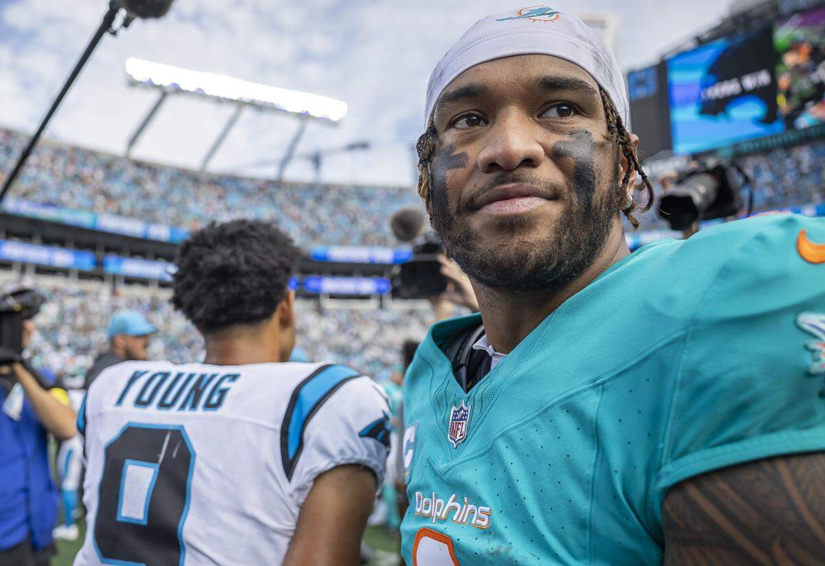 Miami Dolphins quarterback Tua Tagovailoa (1) makes his way off the field after losing to the Carolina Panthers in their NFL game at the Bank of America Stadium on Sunday, Oct. 5, 2025, in Charlotte, N.C.
