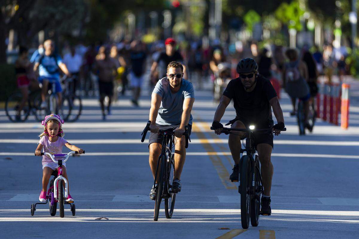 Bikers ride along Ocean Drive in Miami Beach on May 16, 2020, after city officials closed the road to vehicle traffic.