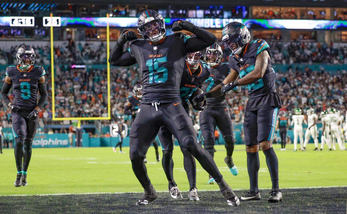 Miami Dolphins linebacker Jaelan Phillips (15) celebrates with teammates after picking up a fumble against the New York Jets during their NFL game in the first half at Hard Rock Stadium in Miami Gardens, Florida, on Monday, September 29, 2025. 