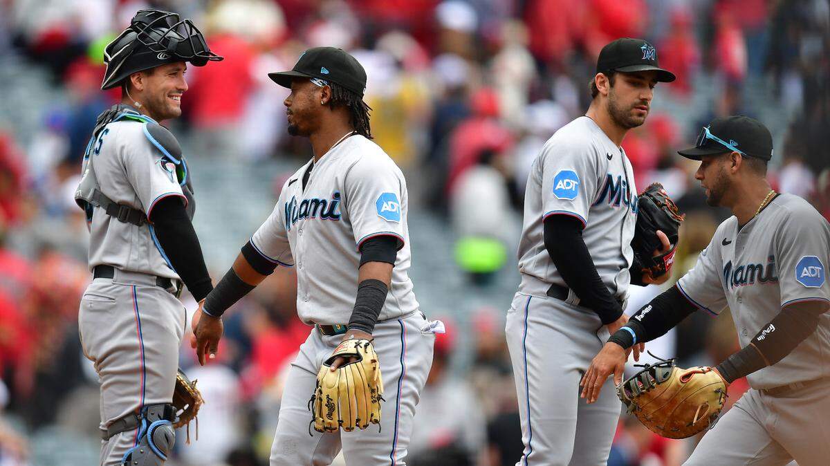 Miami Marlins catcher Nick Fortes (4) and third baseman Jean Segura (9) celebrate the victory against the Los Angeles Angels at Angel Stadium on Sunday, May 28, 2023.