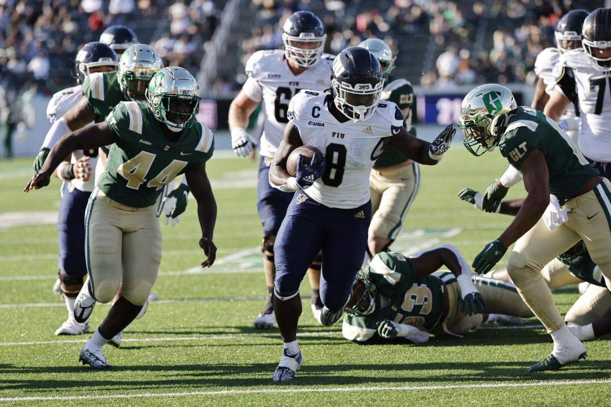 FIU running back Lexington Joseph gains yardage during the Panthers’ 34-15 win at Charlotte on Saturday afternoon.