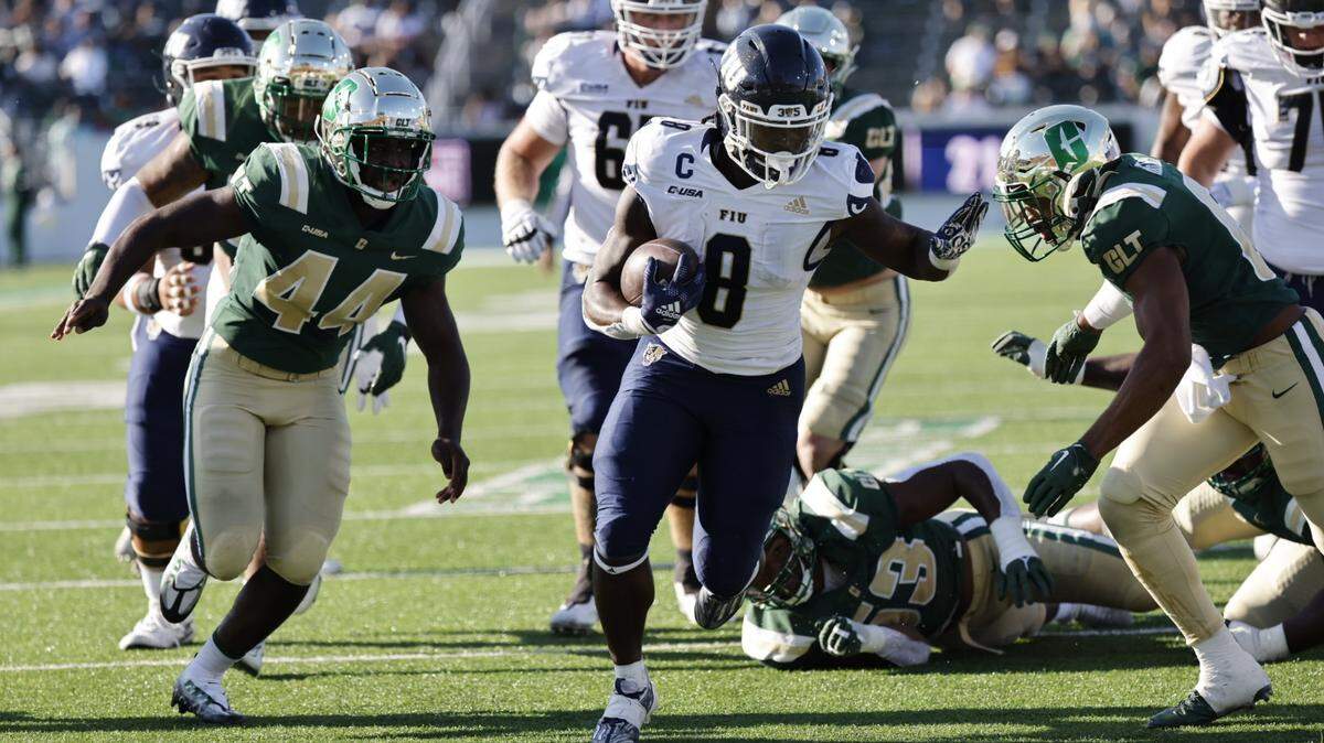 FIU running back Lexington Joseph gains yardage during the Panthers’ 34-15 win at Charlotte on Saturday afternoon.