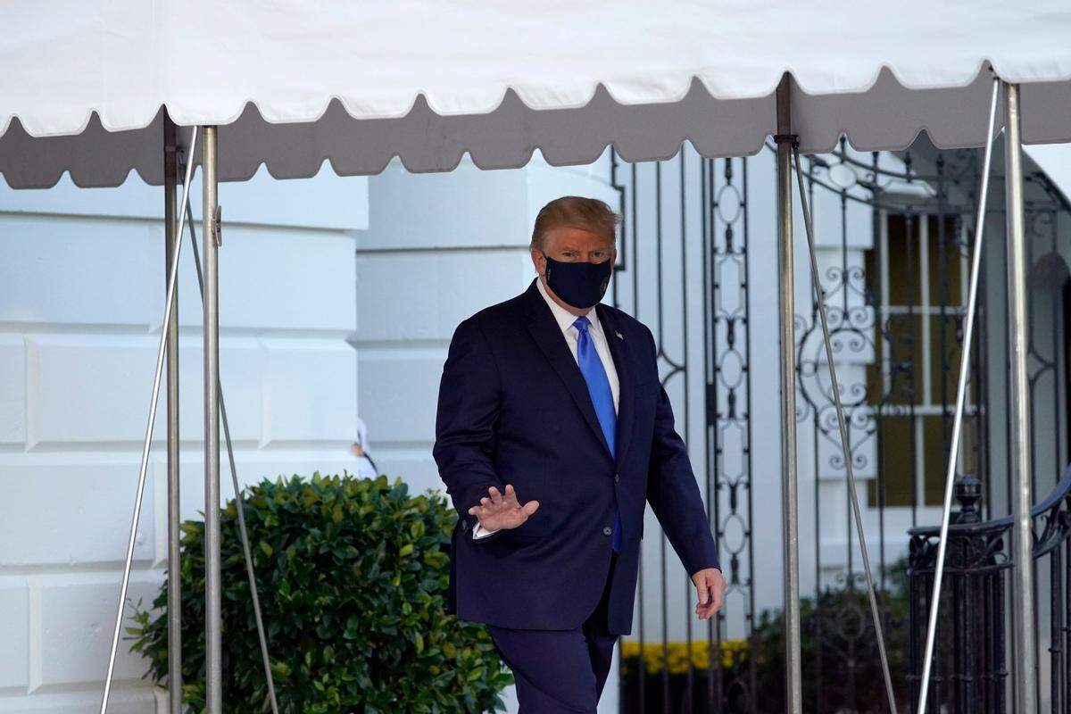 President Donald Trump waves to members of the media as he leaves the White House to go to Walter Reed National Military Medical Center on Friday, Oct. 2, 2020, after he tested positive for COVID-19 in Washington. Trump told the world in a tweet at 12:54 a.m. Friday that he and first lady Melania Trump had contracted COVID-19.