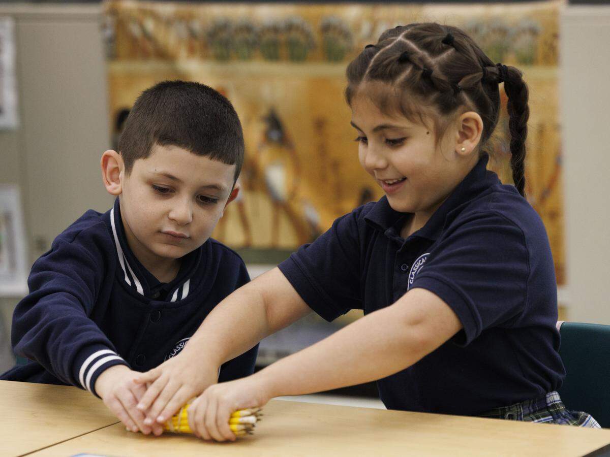 Kindergarten students in the classical education classroom of Ms. Geraldine Cameron participate in a lesson during the school day on Tuesday, Nov. 18, 2025, at Village Green Elementary School in Miami, Fla. Cameron has helped to implement a classical education system at the school that originates from Ancient Greece meant to cultivate critical thinking and virtues in its students, and it disconnects them from technology to focus on active listening.