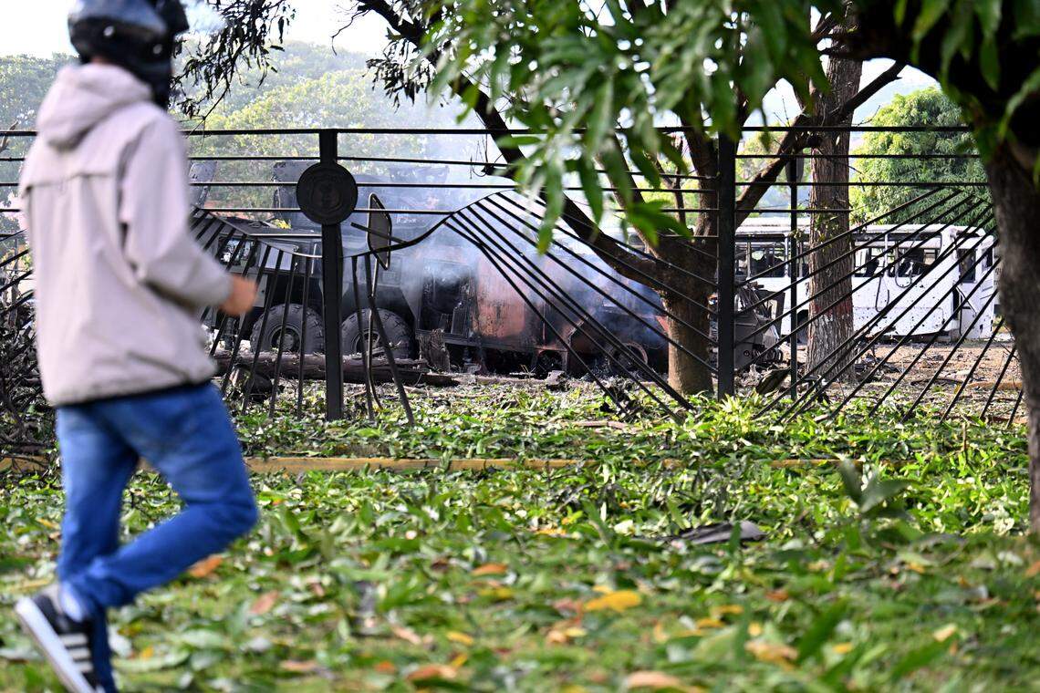 A burnt missile interceptor vehicle is seen at La Carlota air base in Caracas.