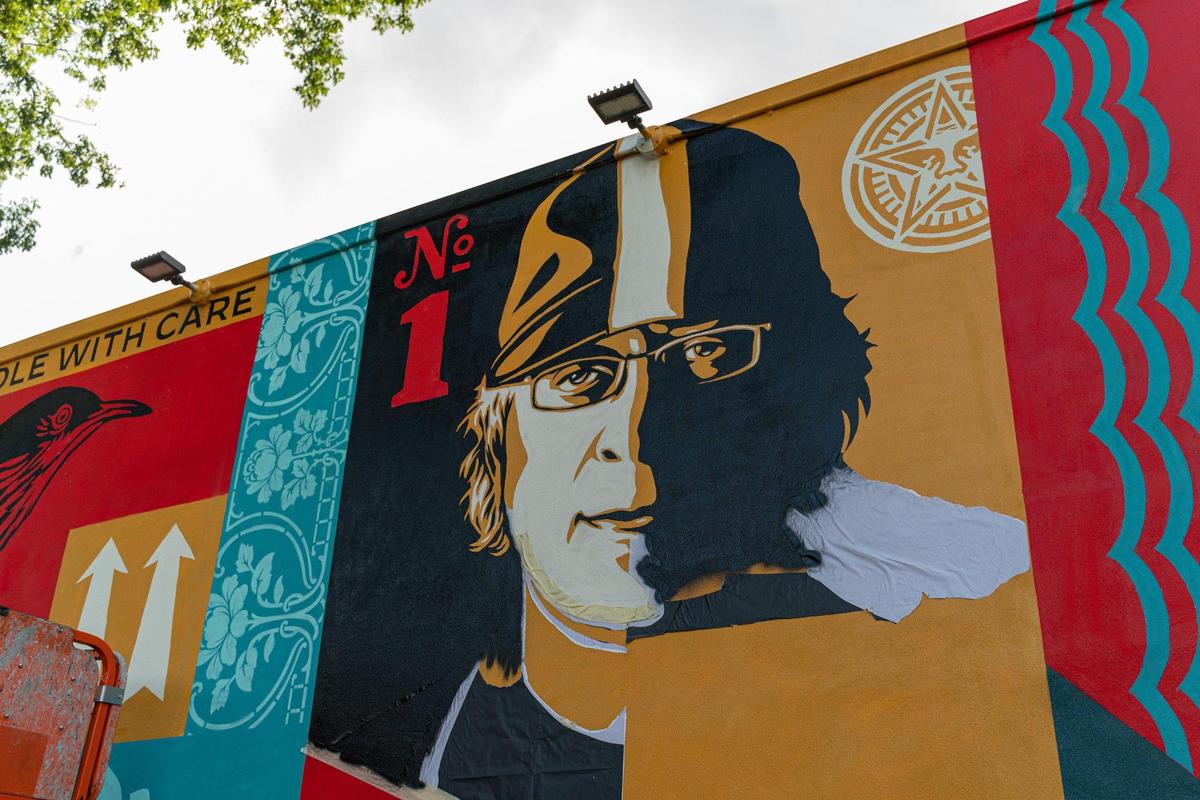 The tribute mural to Tony Goldman is seen in progress while artist Shepard Fairey makes the finishing touches in Miami, Florida on Tuesday, November 22, 2022.