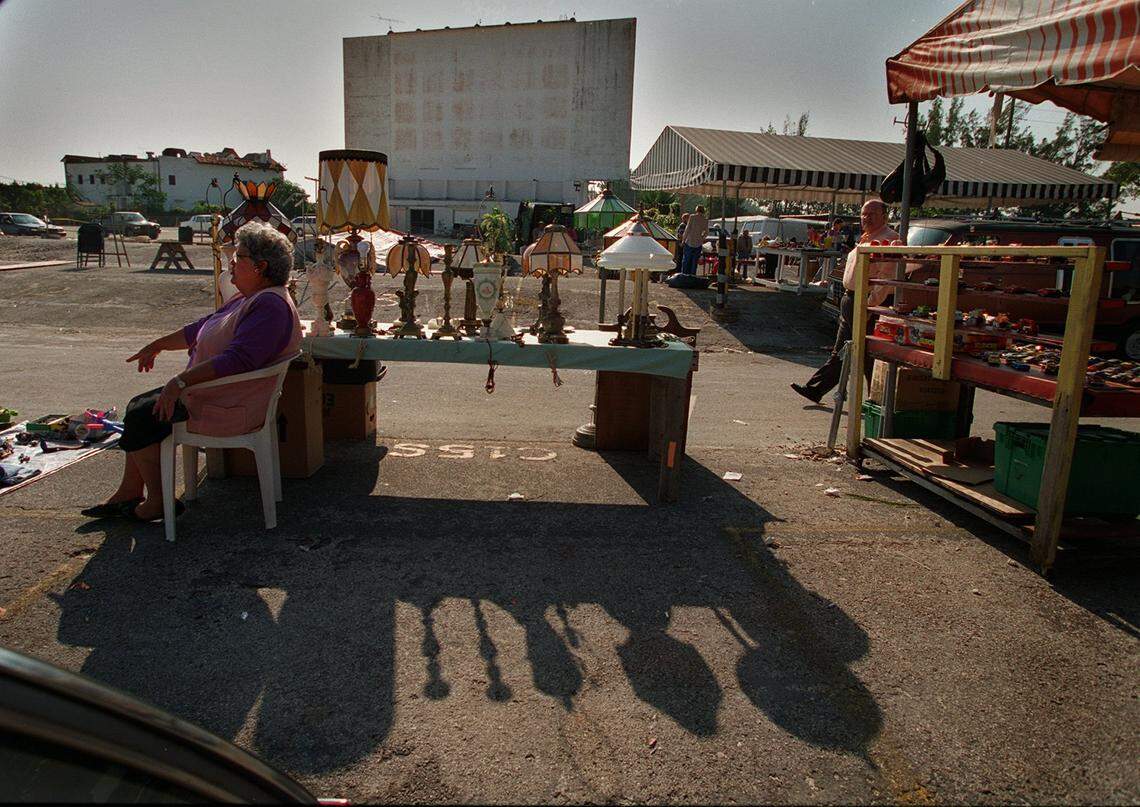 In 1994, Flea market vendors with the old Tropicaire drive-in theater screens in the background.
