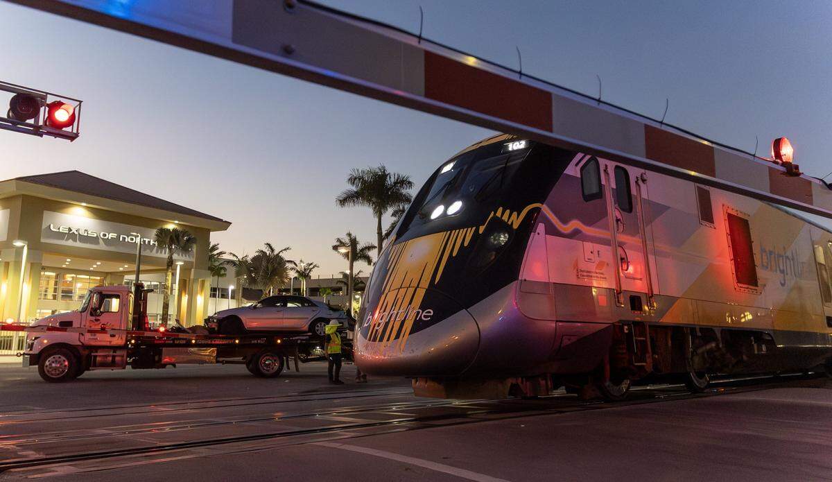 A southbound Brightline train passes the scene of an earlier collision between another Brightline train and a vehicle near the 14100 block of Biscayne Boulevard in North Miami on Wednesday, Nov. 19, 2025. One person was airlifted to a trauma center.