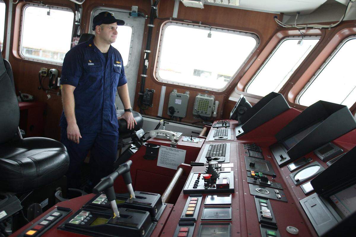 Lieutenant Commander Captain Herb Eggert stands in the pilothouse aboard the new prototype of the US Coast Guard fast response cutter off of Terminal Island in Miami Beach, Florida on Thursday, February 9, 2012. The Coast Guard worries that a proposed residential development nearby would impact its operations.