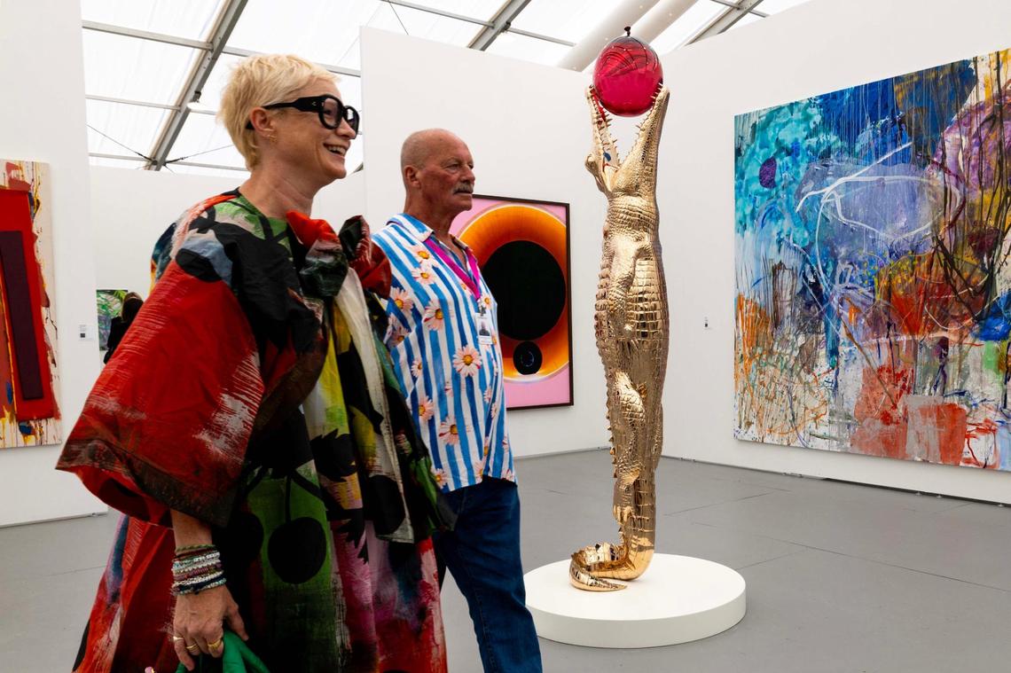 Guests walk past “Touch Too Much” (Ruby Red) by Jiri Geller inside the Untitled Art Fair tent off Ocean Drive for Art Week on Tuesday, Dec. 3, 2024, in Miami Beach, Fla