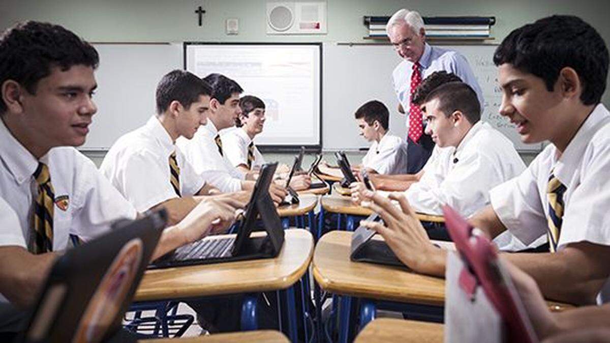 Patrick Collins, rear, a beloved and influential educator at Belen Jesuit Preparatory School, will be honored on Sept. 25.