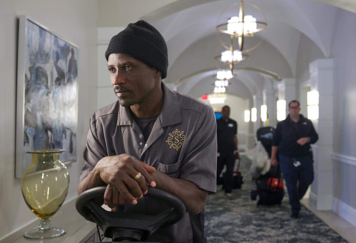 Ronald Estime, 47, left, a custodial worker and former Temporary Protected Status recipient, operates a commercial rug-cleaning machine at Sinai Residences in Boca Raton, Florida,  on Thursday, Jan. 29, 2026.  Many employees who currently have TPS now fear deportation.