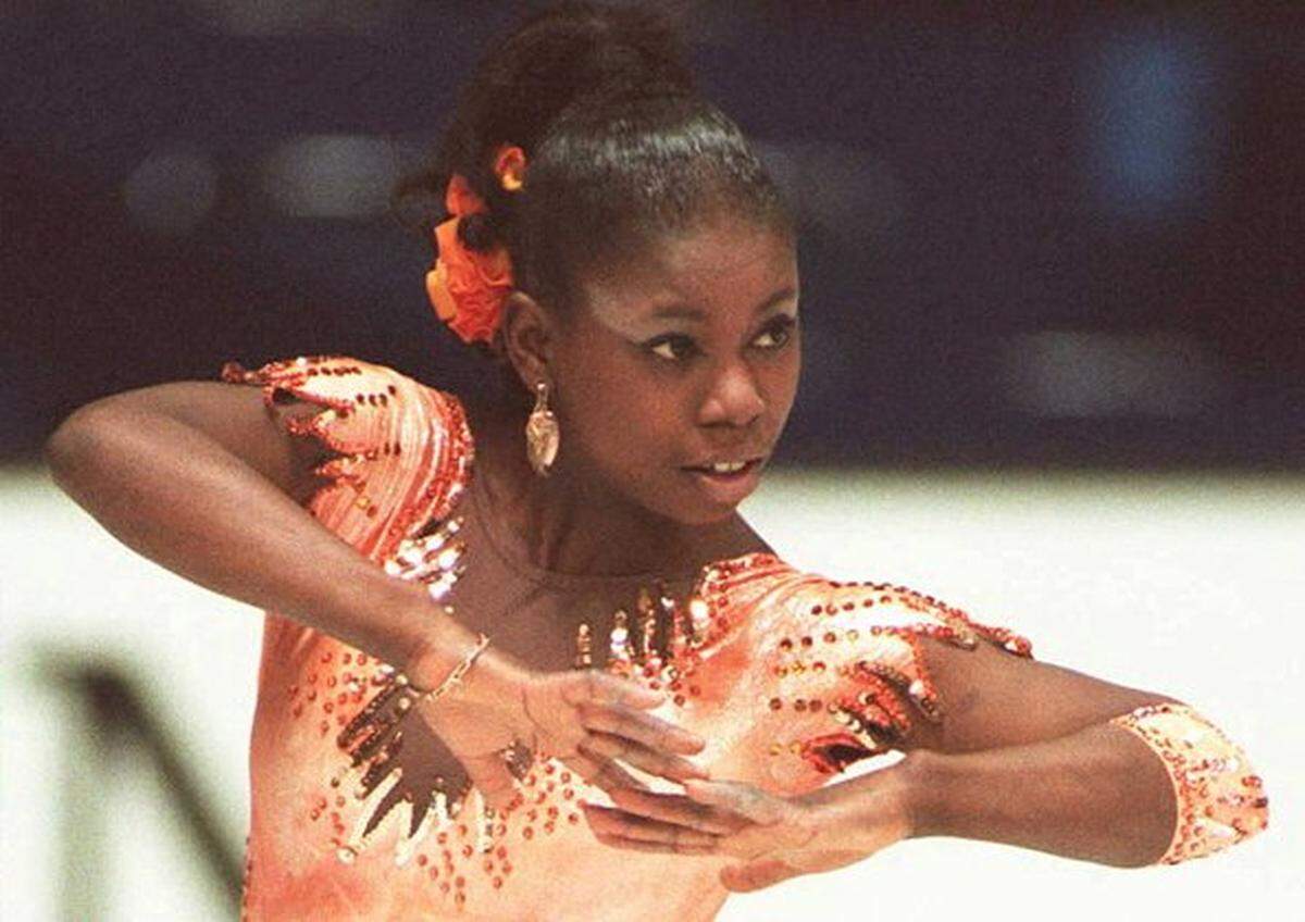 French skater Surya Bonaly performs, 03 February in Dortmund, Germany, during the women's technical program in the European figure skating championships. Bonaly placed second in the event behind Russia's Olga Markova. (COLOR KEY: Flower is orange. AFP PHOTO (Photo by Vincent AMALVY / AFP via Getty Images)