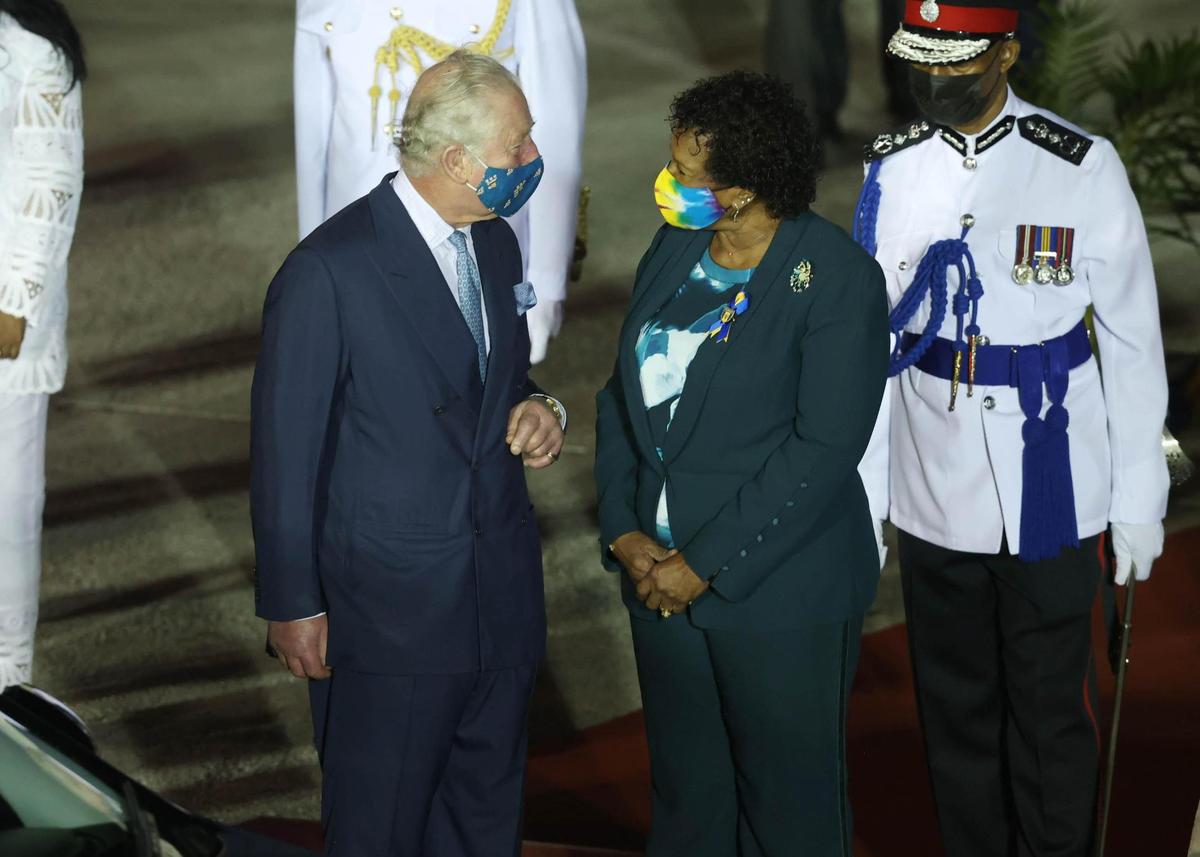 Prince Charles is greeted by Dame Sandra Mason as he arrives at Bridgetown Airport on Nov. 28, 2021, in Bridgetown, Barbados. The Prince of Wales arrived in the country ahead of its transition to a republic within the Commonwealth. This week, it formally removes Queen Elizabeth as its head of state and Mason, the current governor-general, will be sworn in as president.