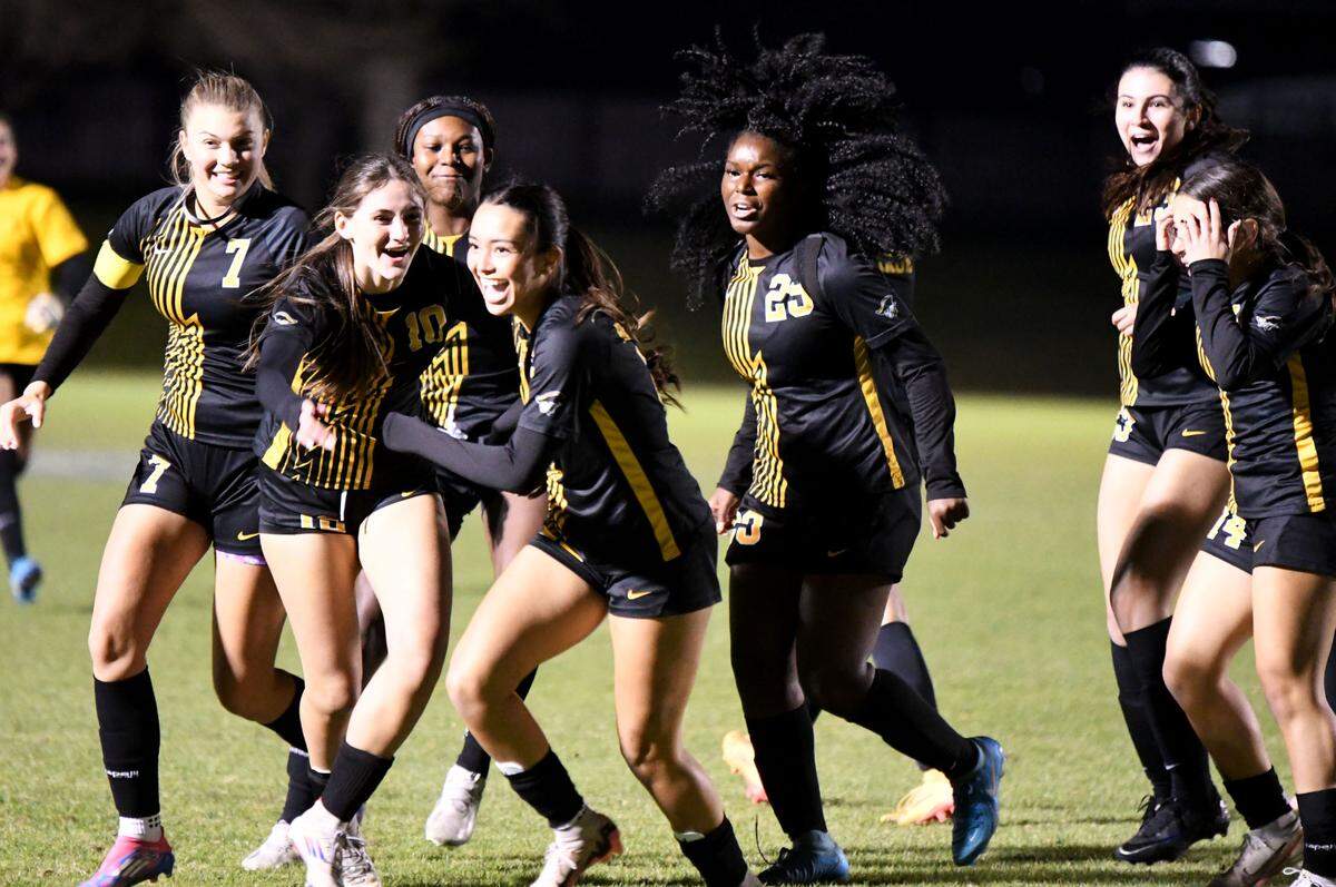 American Heritage players celebrate scoring a first-half goal against Orlando Bishop Moore during the Class 4A girls soccer state championship game on Friday at Lake Myrtle Sports Complex.