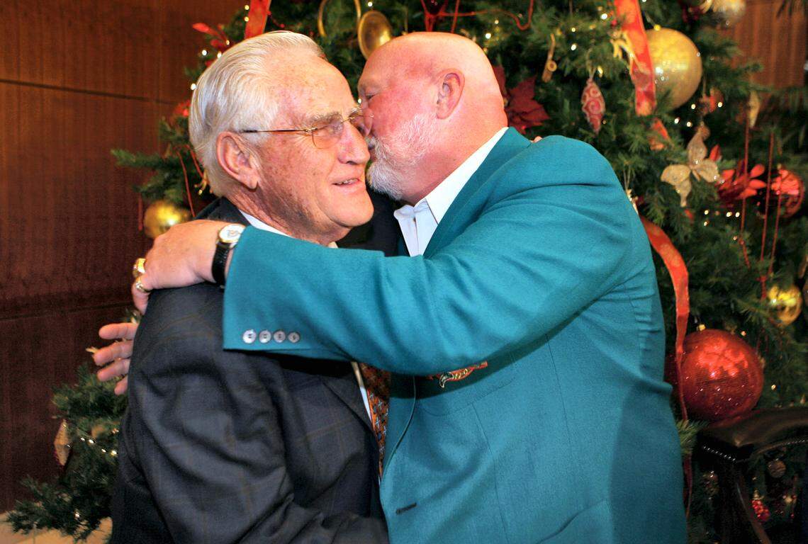 Former Miami Dolphins head coach Don Shula, left, gets a hug and kiss from former NFL football player Bob Kuechenberg during Shula’s 80th birthday party being held at the Land Shark Stadium in Miami, Saturday, Jan. 2, 2010. Shula led the Dolphins franchise to its most recent Super Bowl title 36 years ago. (AP Photo/Jeffrey M. Boan)