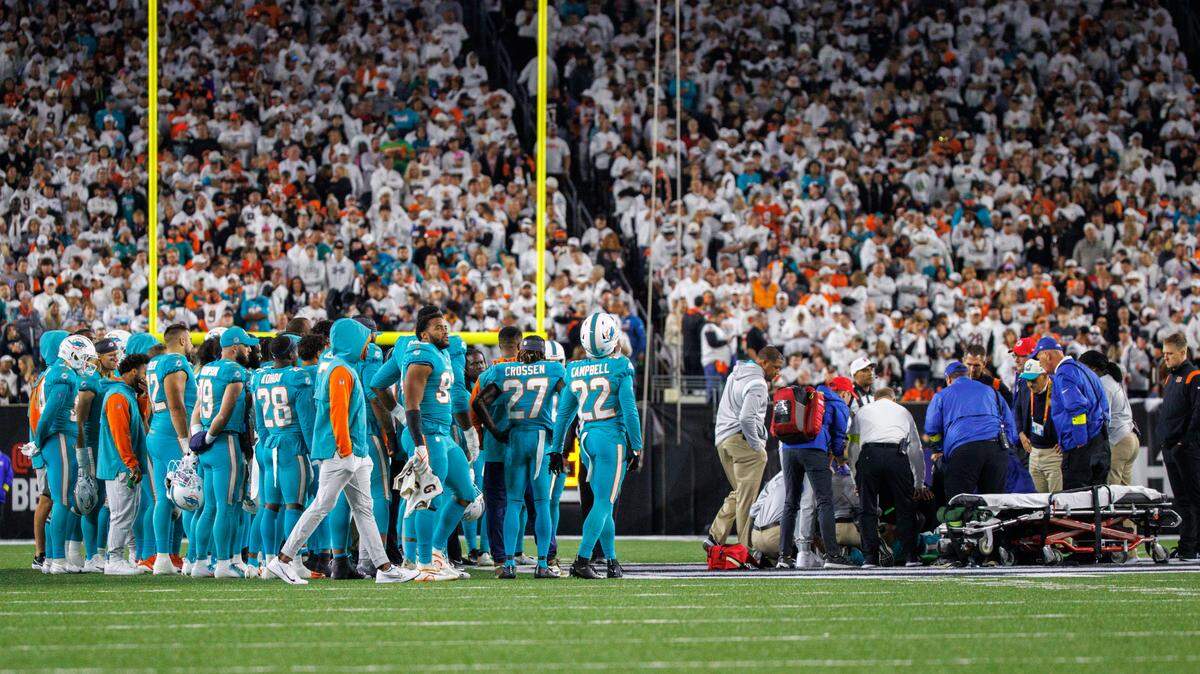 Miami Dolphins players stand next to teammate quarterback Tua Tagovailoa (1) after he got injured in a play being during the second quarter of an NFL football game against the Cincinnati Bengals at Paycor Stadium on Thursday, September 29, 2022 in Cincinnati, Ohio.